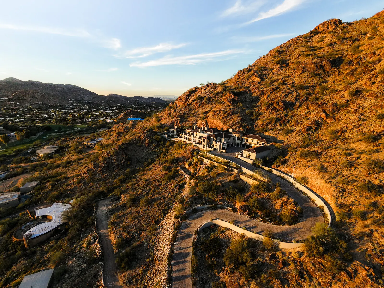 Custom homes built into a desert hillside with the valley beyond